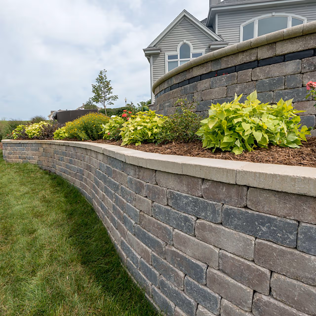 Professional retaining wall construction by Roi Property Services for drainage control and structural support in Metro Detroit