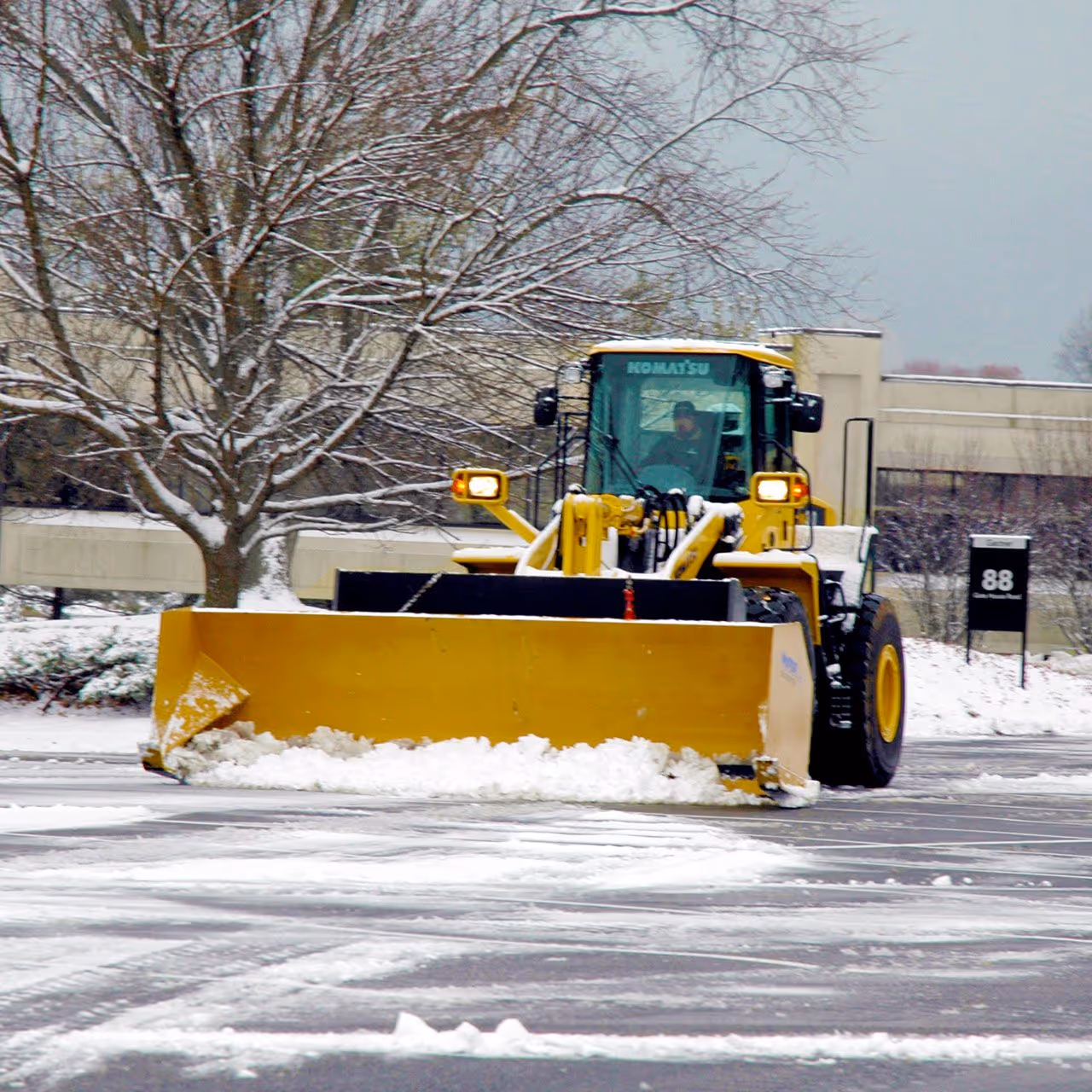 Commercial grounds maintenance crew performing snow removal by Roi Property Services in Metro Detroit