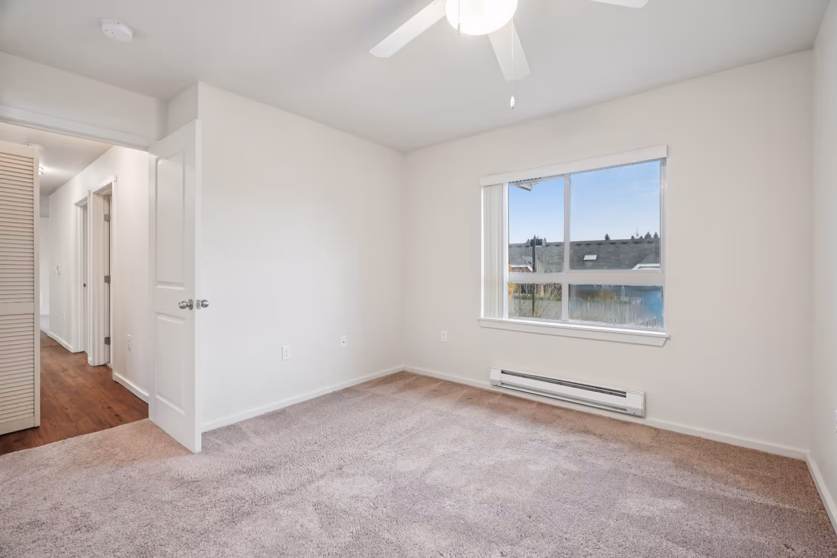 Copper Lane 3x2 Primary Bedroom with window and carpet