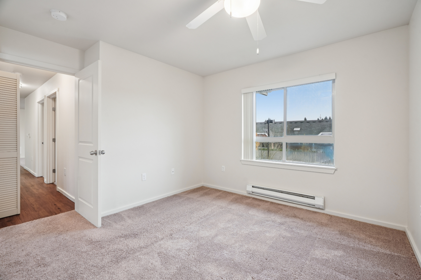 Copper Lane 3x2 Primary Bedroom with window and carpet
