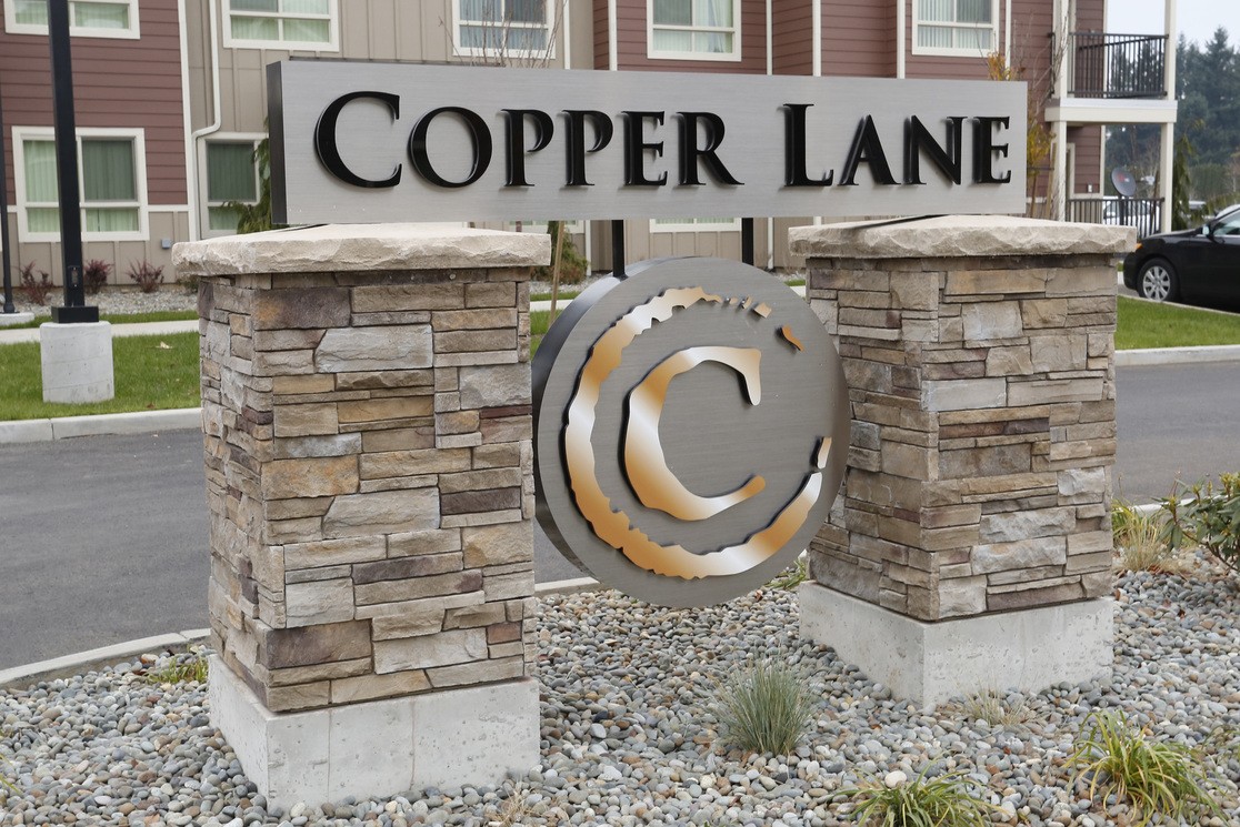 Monument entrance sign for Copper Lane Apartments, a modern apartment community with affordable homes and resident amenities
