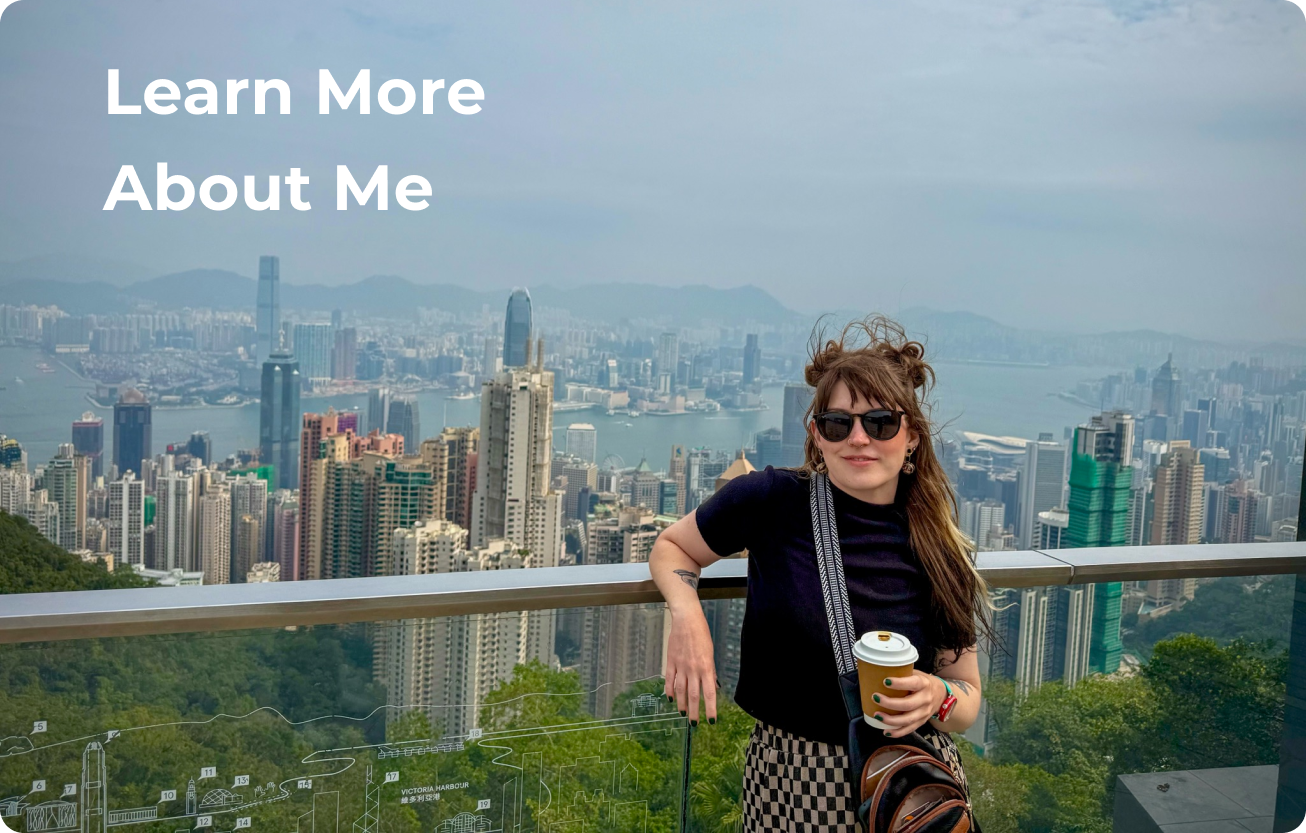 A woman leaning on a railing high above a the city of Hong Kong behind her with the words "Learn More About Me" featured in the top left corner of the image