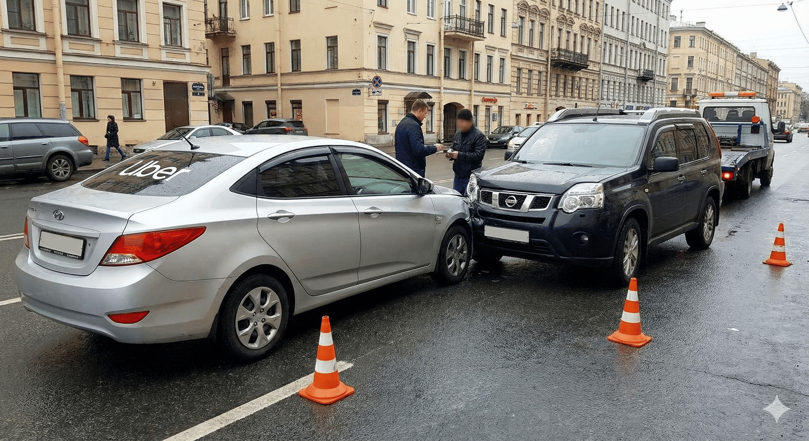 White Mercedes van with a smashed front and cracked windshield on a busy highway with traffic and emergency vehicles in the background.