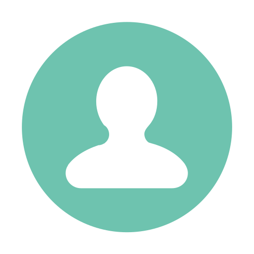 Portrait of a young man with blond hair and blue eyes wearing a light grey sweatshirt against a blurred brown background.