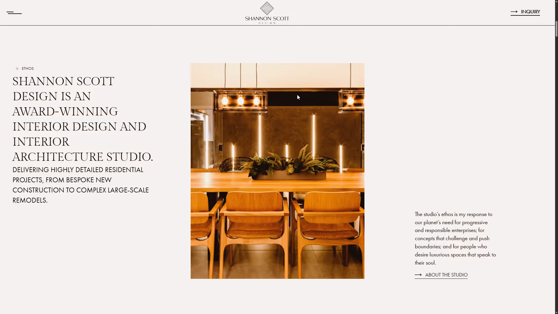 Modern wooden dining table with six chairs and a rectangular planter centerpiece under three hanging pendant lights in a stylish interior.