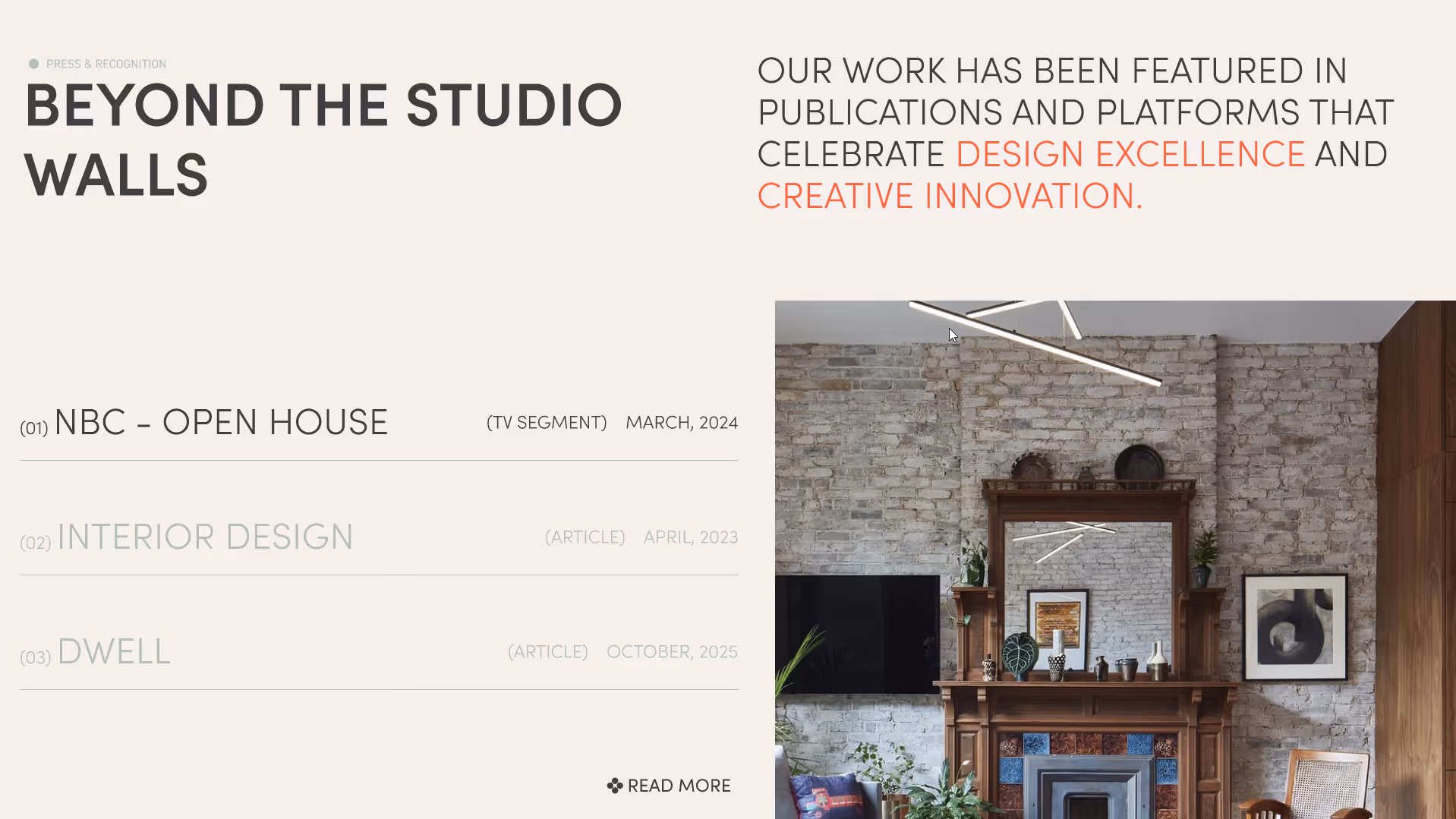 Interior with a decorative wooden fireplace mantel, a mounted flat-screen TV on an exposed brick wall, framed artwork, a chair, and modern lighting.