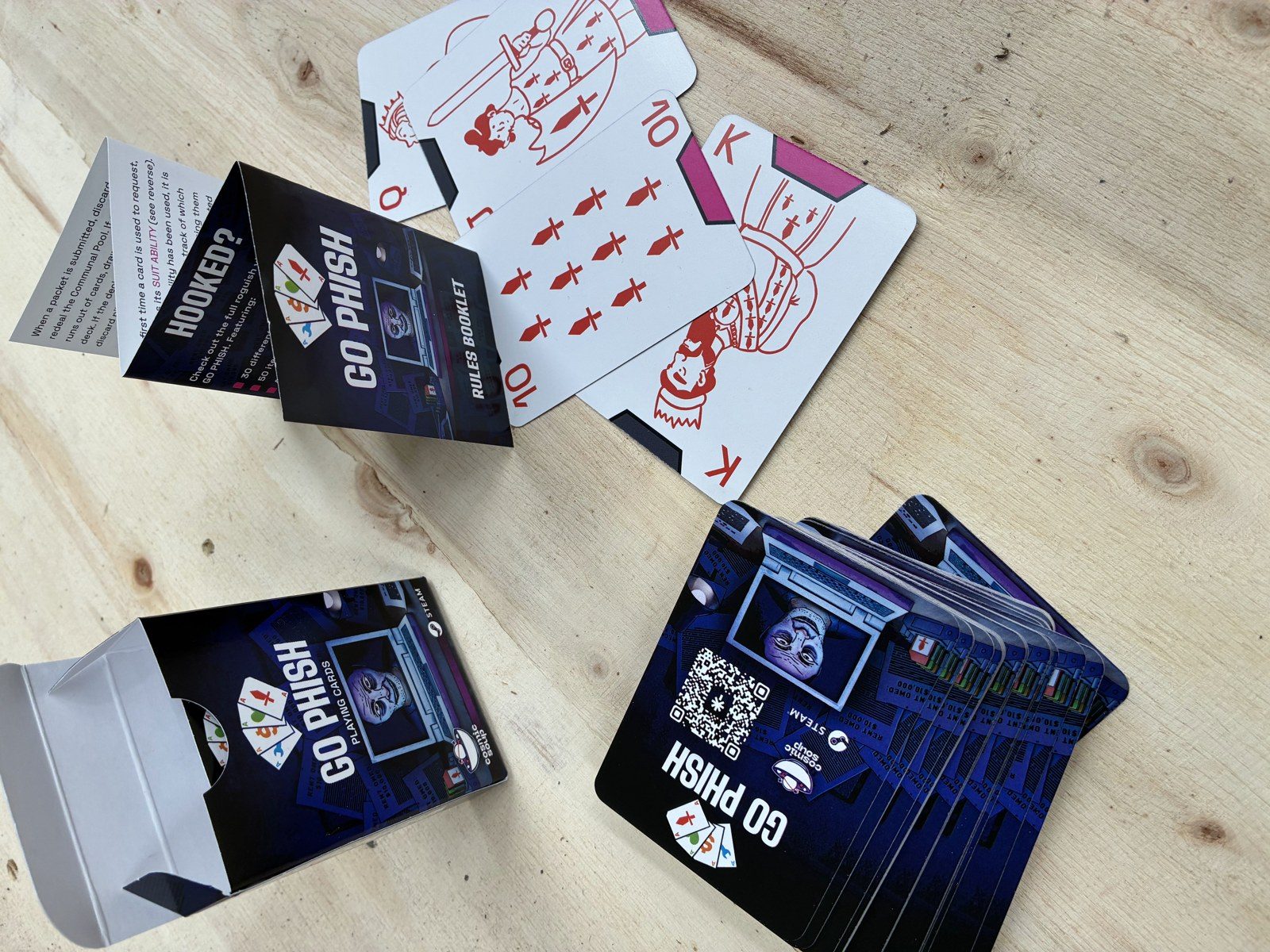 Go Phish card backs printed in New Zealand, showing the QR code linking to the game's Steam page on a dark blue background