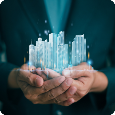 Hands holding a digital hologram of modern commercial buildings with a dark background.