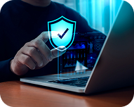 Person holding a holographic shield with a checkmark in front of a laptop, symbolizing cybersecurity protection.