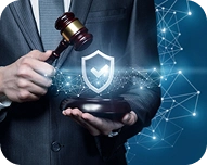 Businessman holding a gavel above a tablet displaying a glowing shield with a checkmark, symbolizing protection and legal security.