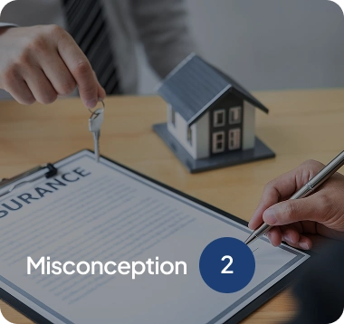 Person holding a key over an insurance document with a small model house and another person signing the document.