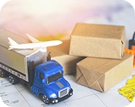 Miniature blue truck with container, toy airplane, and stacked cardboard boxes representing freight shipping and cargo insurance.