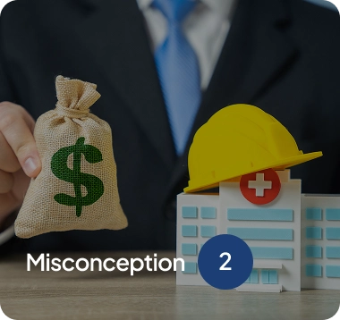 Person in suit holding a burlap money bag with a green dollar sign next to a hospital model topped with a yellow construction helmet.