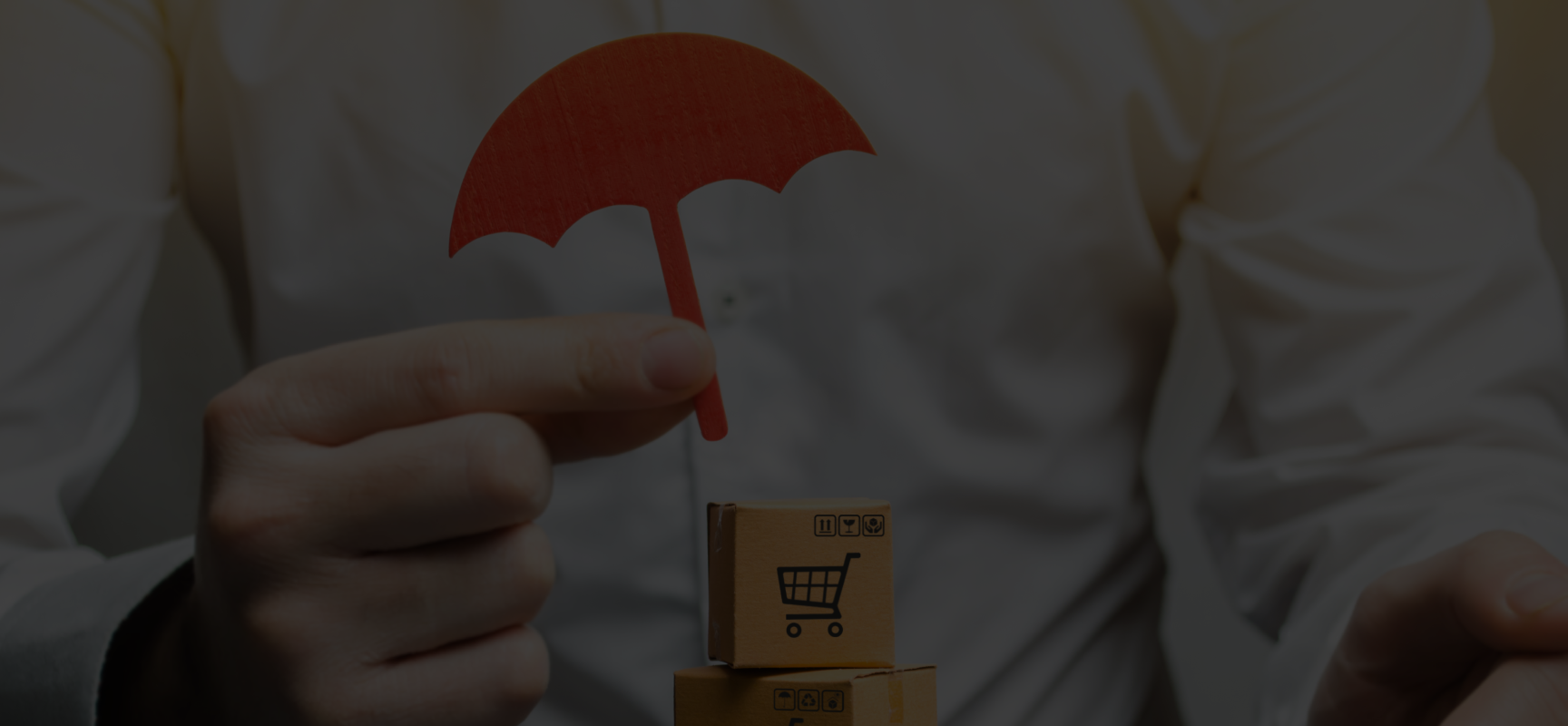 Person holding a small red umbrella over stacked cardboard boxes with shopping cart icons.