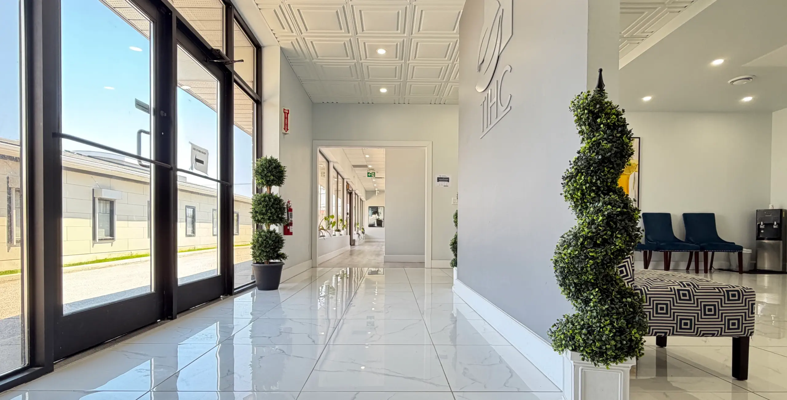 entrance of the trenton integrative health centre showing seating in the waiting area and the hallway to treatment rooms