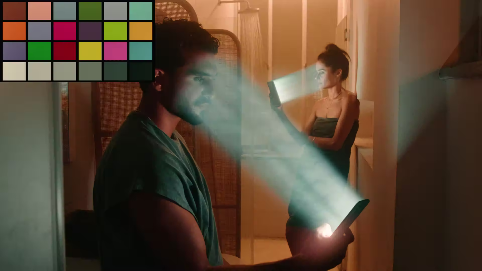 Man and woman in a dimly lit room using smartphones with beams of light projecting from the screens.