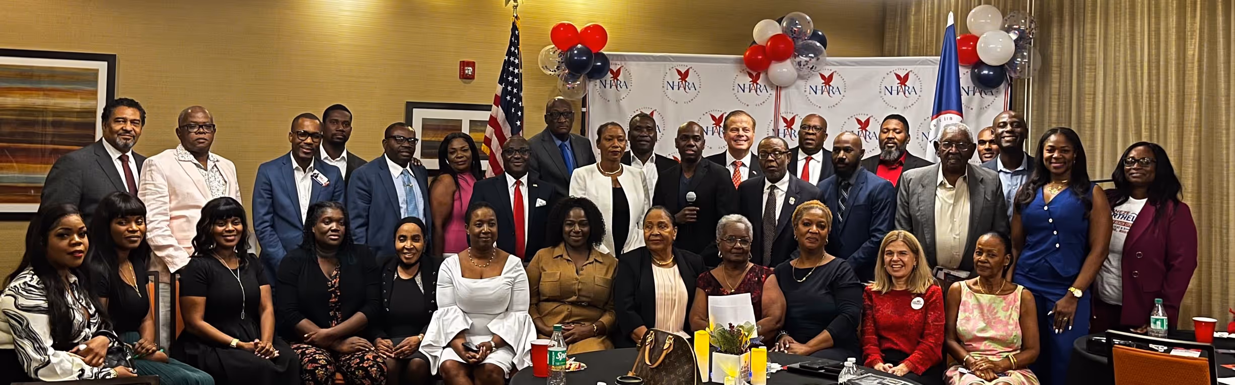 A diverse group of men and women posed in a conference room.