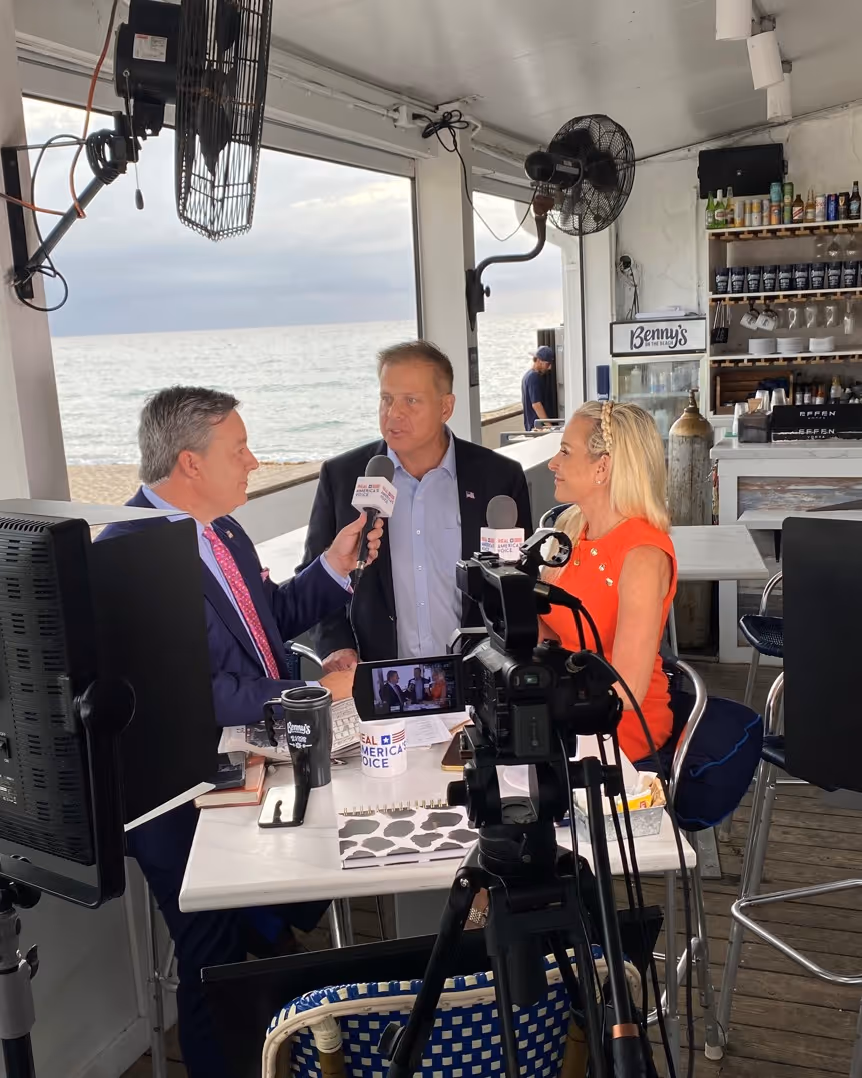 Three people seated at a table.