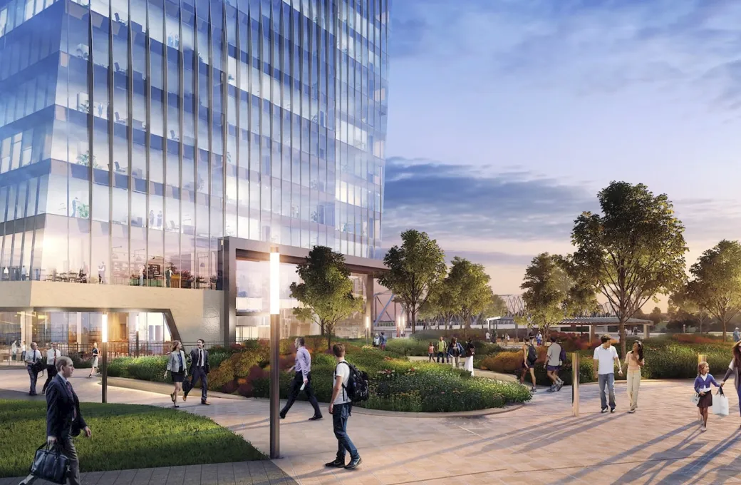 A large building with many windows and a group of people walking outside.
