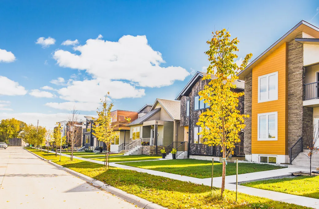 A row of houses with a yellow house in the middle.
