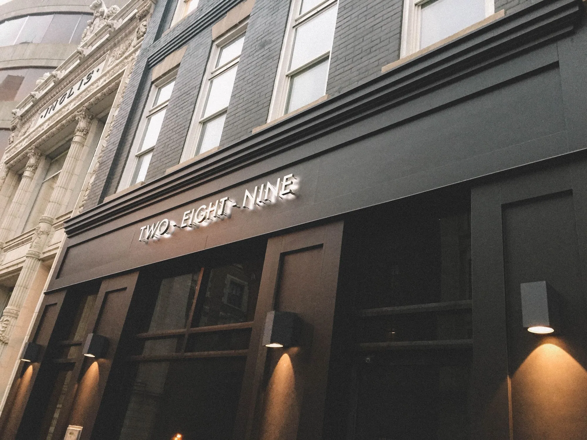 A black building with a sign that says "Twelve and Nine".