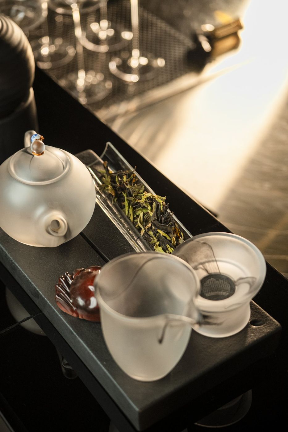 A Chinese tea set with loose leaves on a stone tray at FOOM