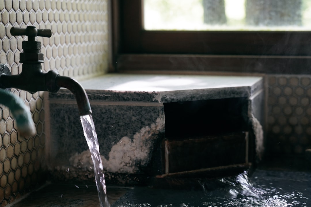A leaking water heater tank with a small puddle forming at the base - affordable water heater replacement in silverdale, wa A leaking water heater tank with a small puddle forming at the base - affordable water heater replacement in silverdale, wa