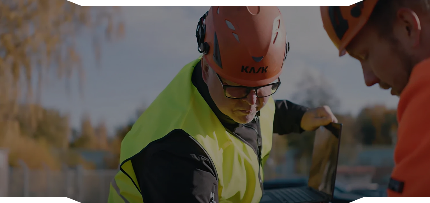 Fitters in helmets and hi-vis vests reviewing the work out on the yard
