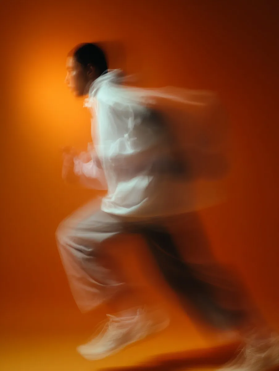 A blurry photo of a man running.