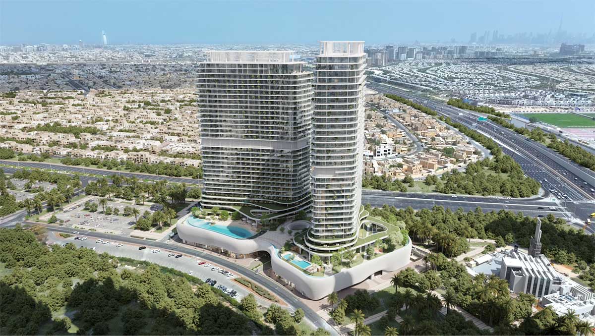 Aerial exterior view of SAAS Hills in Dubai Science Park, showing the twin residential towers, landscaped podium, pools and surrounding urban context