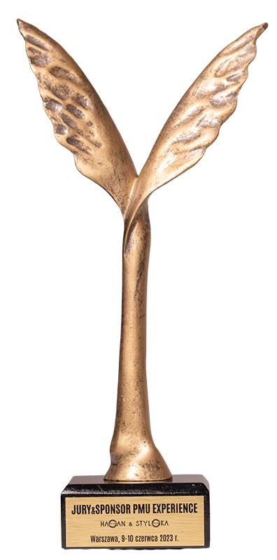 Złota statuetka dwóch skrzydeł na czarnej podstawie z napisem jury i sponsor PMU Experience Warszawa, 9-10 czerwca 2023.