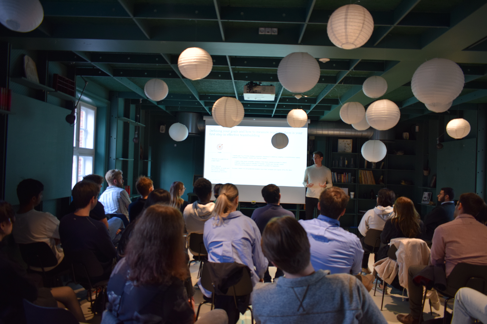 Final event presentation session with teams and partners present.