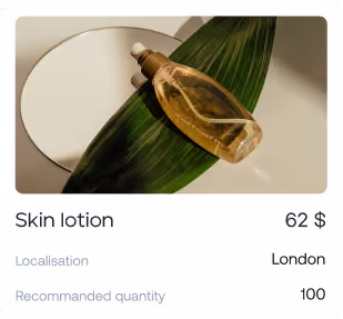 Clear bottle of skin lotion with a white cap resting on a green leaf and a white plate.