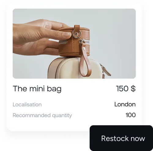Hand holding a small brown leather mini bag above a larger beige bag with pricing and stock details.