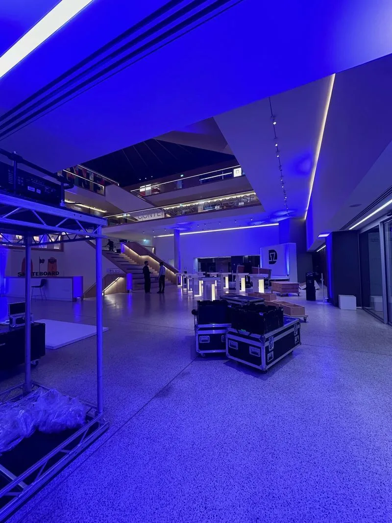 Production equipment in blue lit hall.