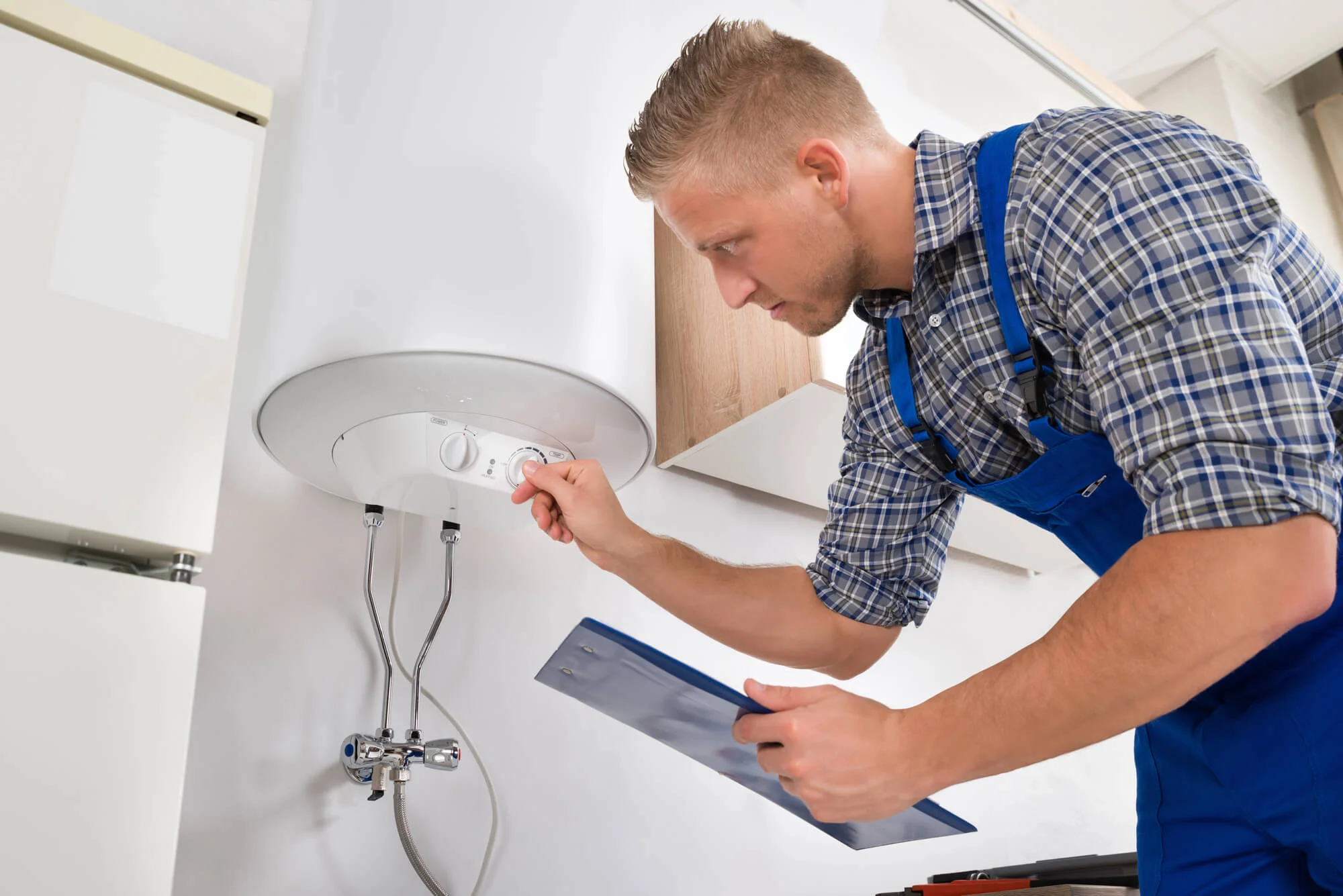 Technician checking water heater repair in Vista, CA.
