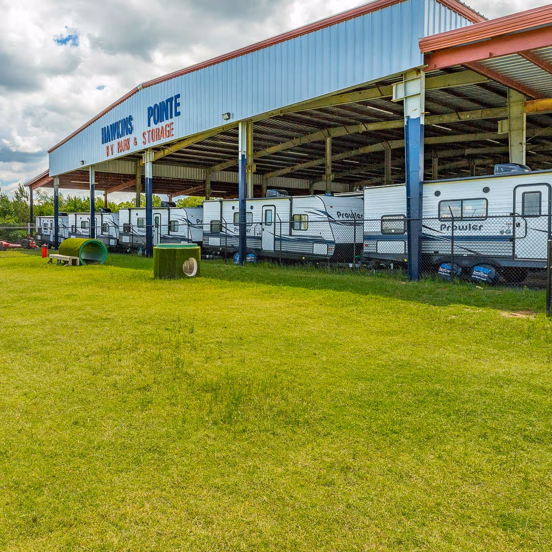 Hawkins Pointe dog park with outdoor covered storage in the background.