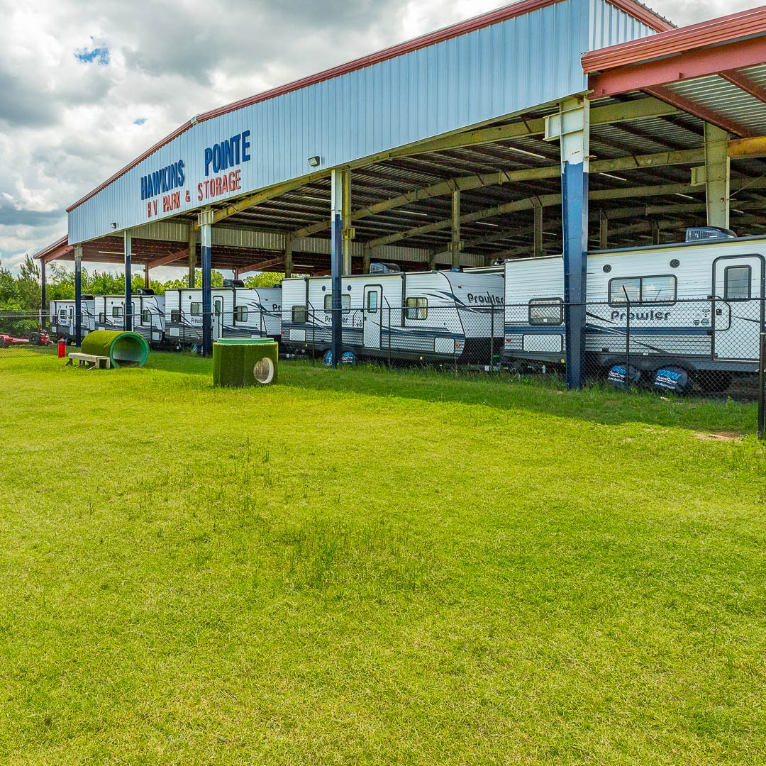 Hawkins Pointe dog park with outdoor covered storage in the background.