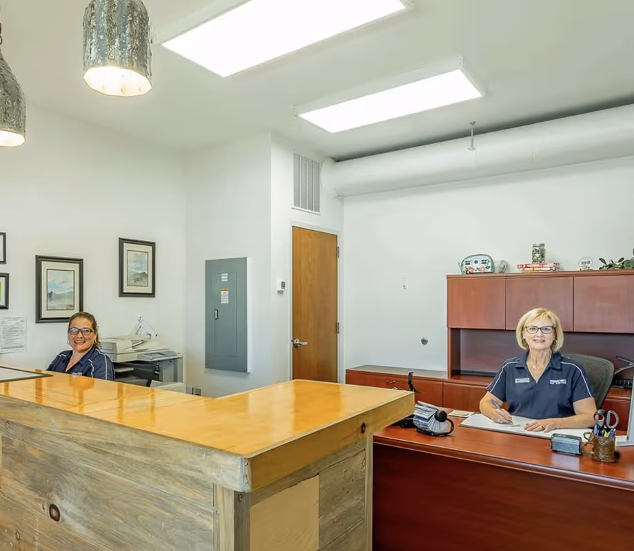 Reservation Specialist Cathey and Co-Owner Karen Hawkins at the check-in desk.