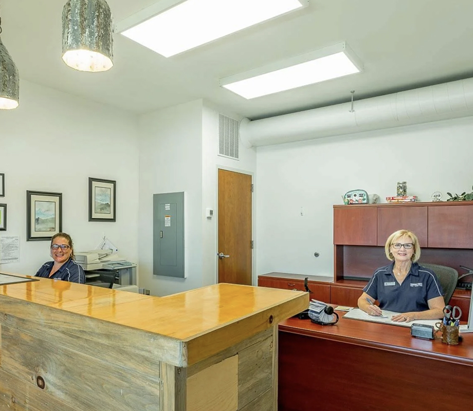 Reservation Specialist Cathey and Co-Owner Karen Hawkins at the check-in desk.