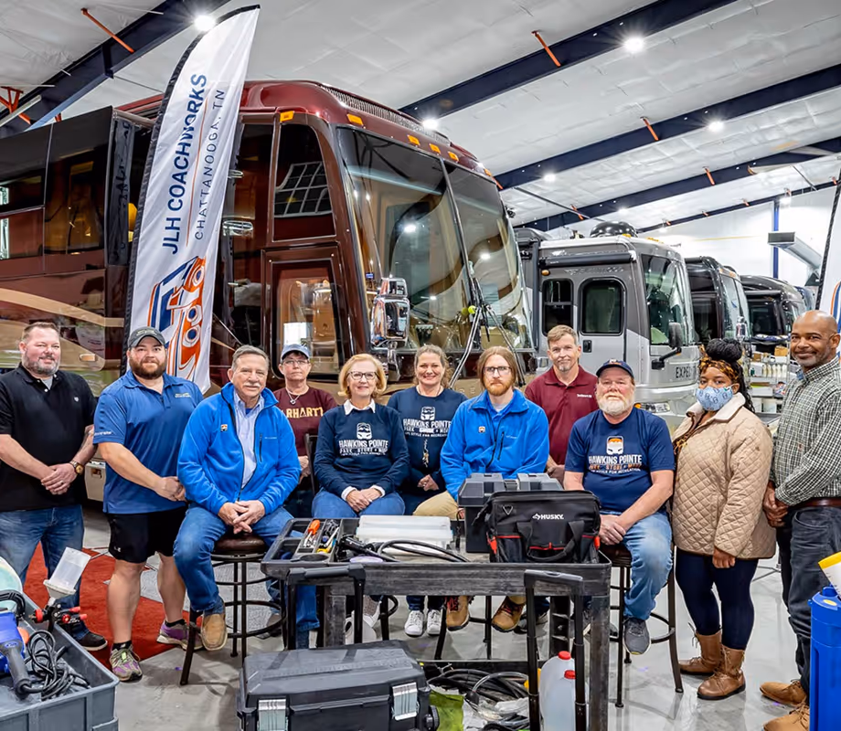 The Hawkins Pointe and JLH Coachworks team in the indoor luxury storage area.