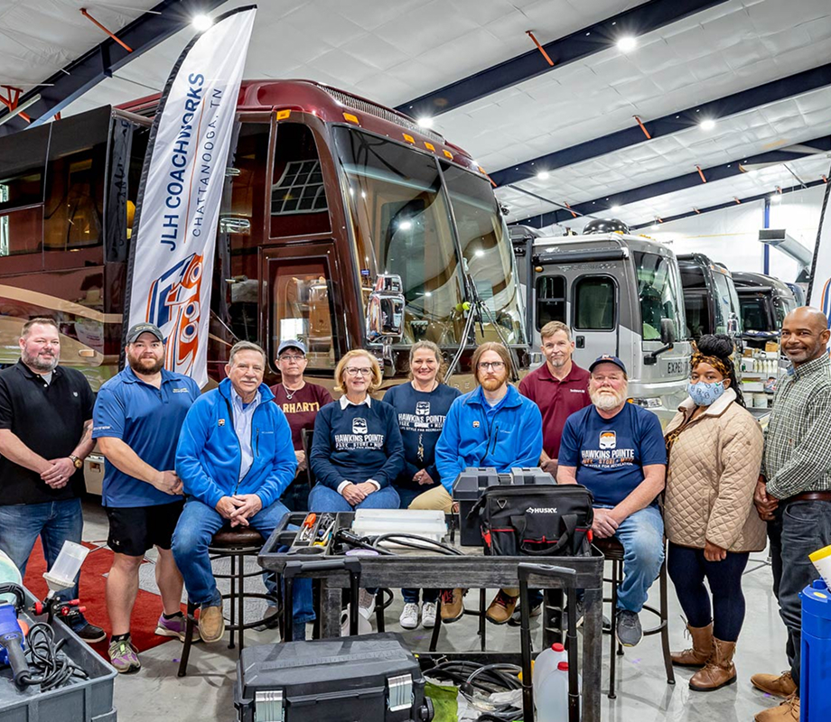 The Hawkins Pointe and JLH Coachworks team in the indoor luxury storage area.