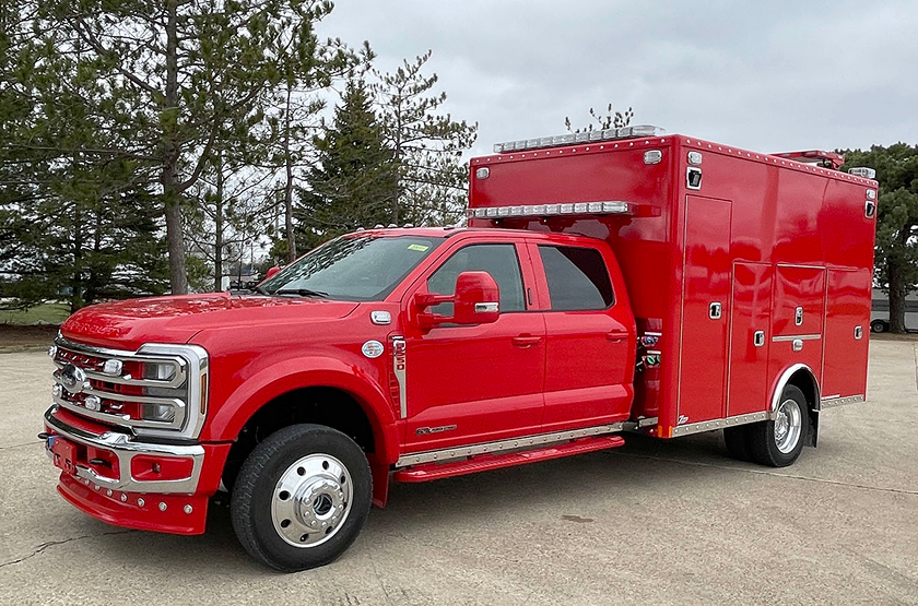RV technician entering a motorhome with toolbox.