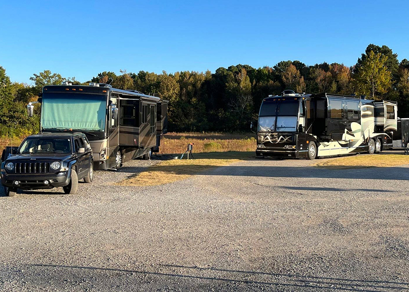  RV technician entering a motorhome with toolbox.
