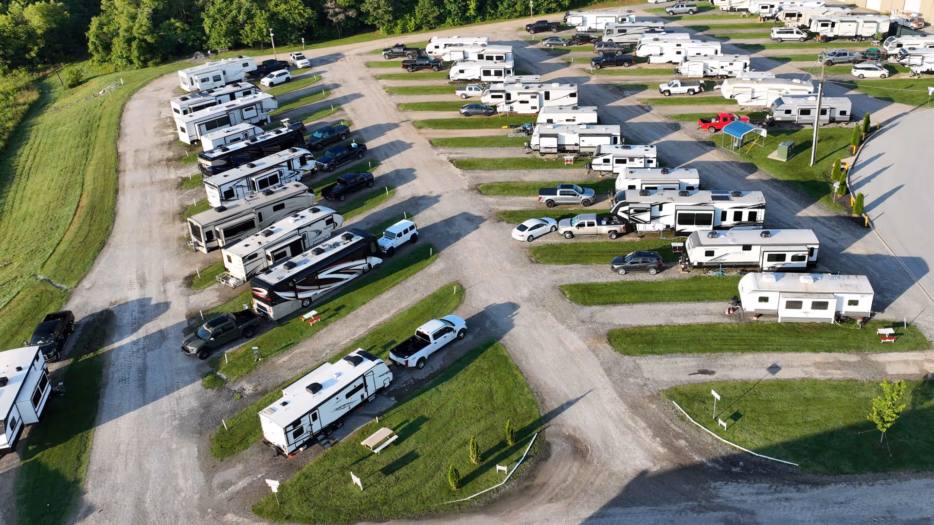 Aerial view of Hawkins Pointe with numerous parked RVs and pickup trucks arranged on gravel roads and grassy slots.