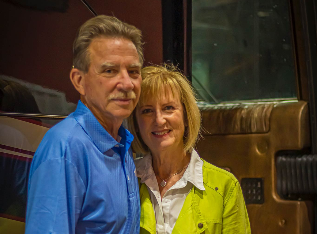 John and Karen outside a motorcoach entrance at Hawkins Pointe.