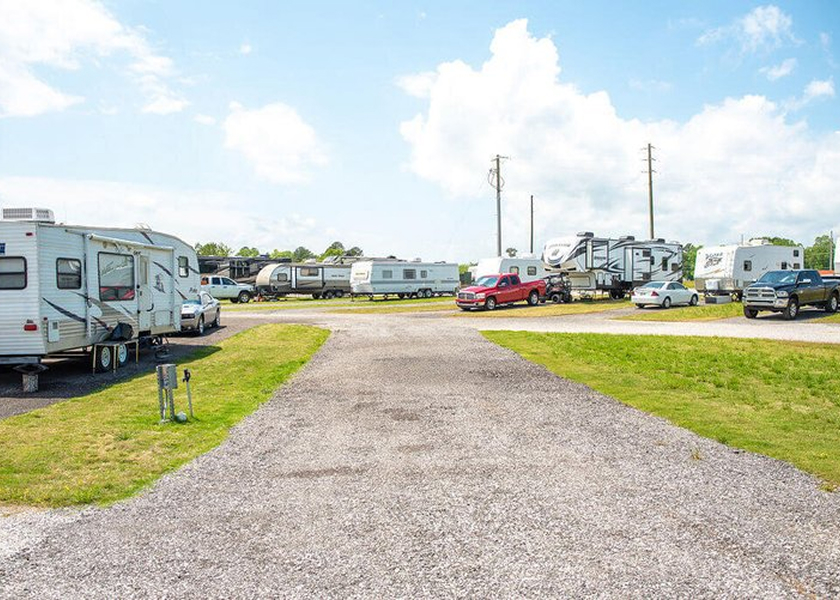  RV technician entering a motorhome with toolbox.