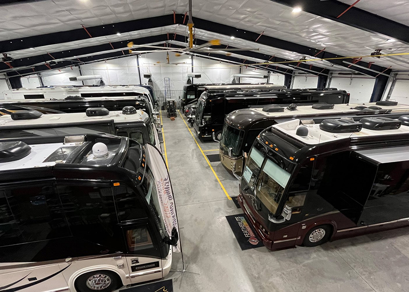  RV technician entering a motorhome with toolbox.