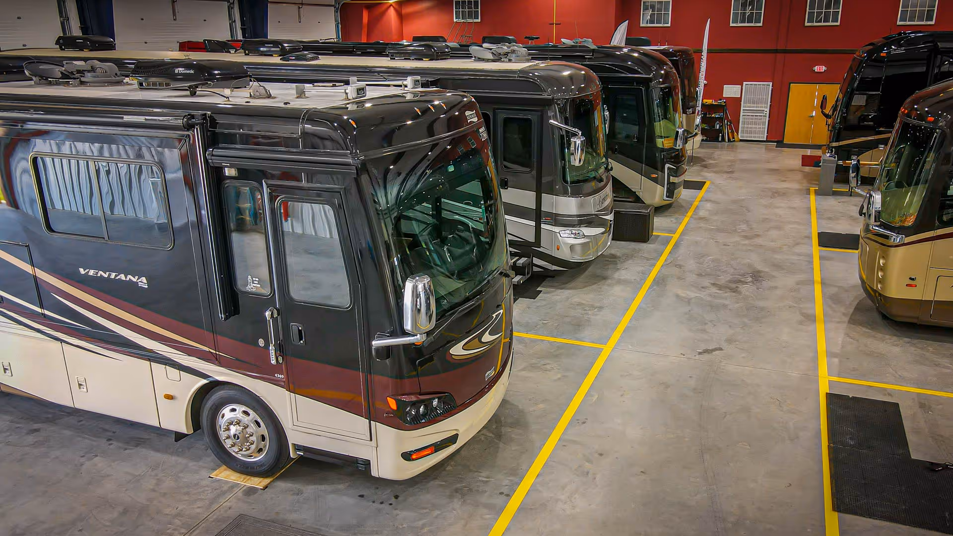Inside our Luxury Storage facility with multiple motorhomes parked inside.