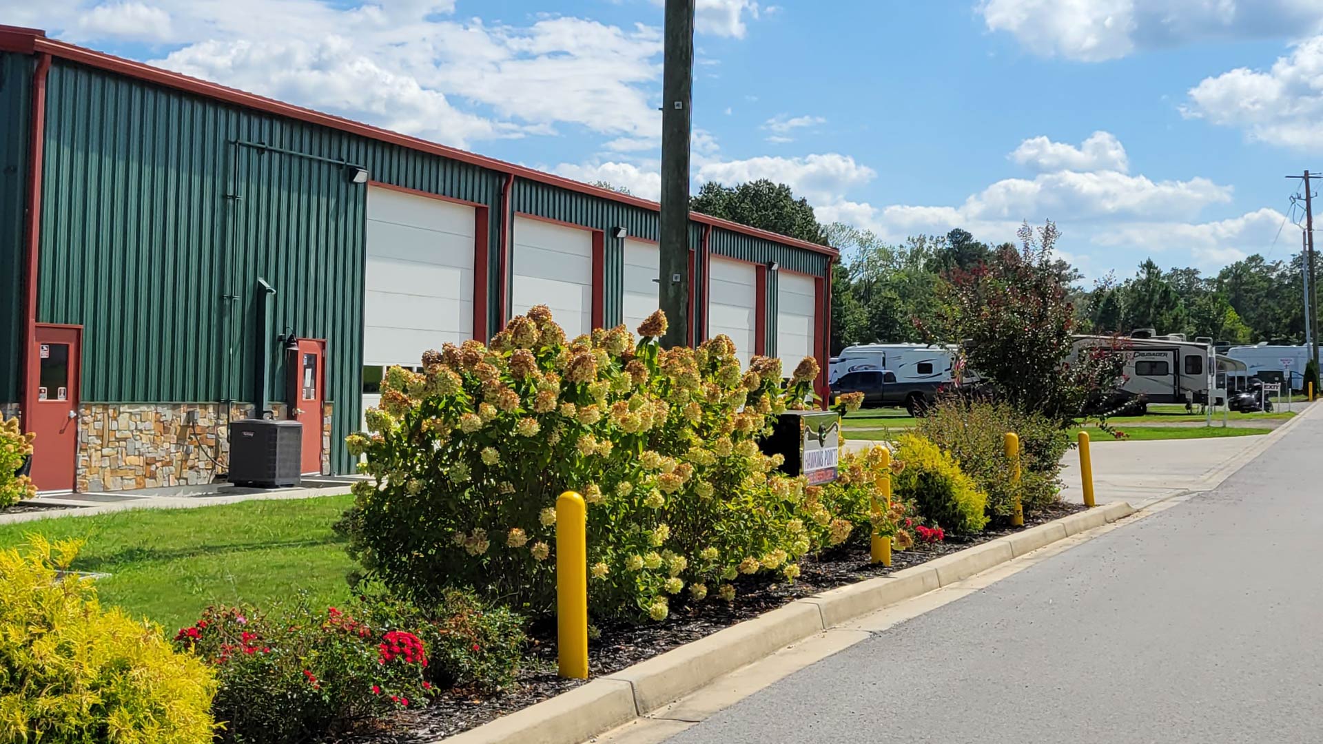 Outside Hawkins Pointe Luxury Storage facility with landscaping.